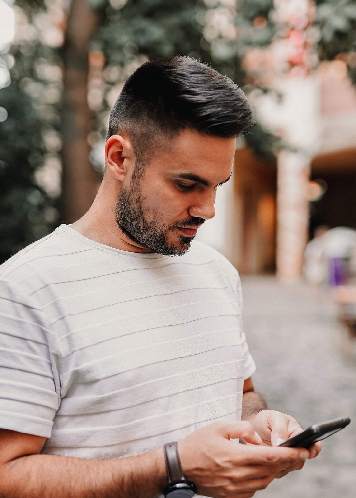 Image of a man looking down at his phone. This image represents what phone coaching with a DBT therapist in Los Angeles, CA may look like. Those in a DBT program in Torrance, CA get support over the phone. | 90274 | 90275