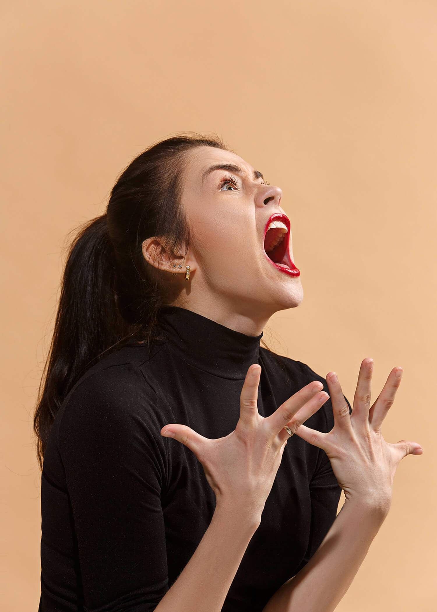Image of a woman wearing red lipstick screaming in anger. Those struggling with anger issues in Los Angeles, CA can learn skills from a DBT therapist about managing anger in Los Angeles, CA. | 90274 | 90275