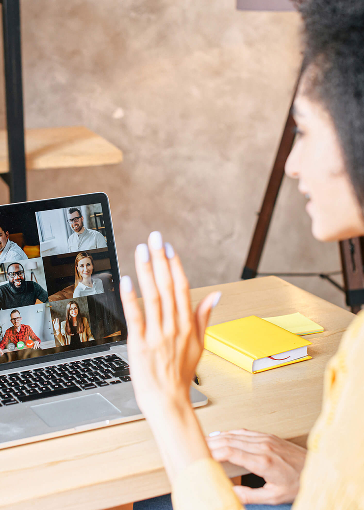 Image of a woman waving at a group of people on her laptop screen. This image depicts what a DBT skills group using online therapy in Las Vegas may look like. Dialectical behavior therapy in Las Vegas can help you remove unhealthy behaviors. | 89166 | 89138 | 89135