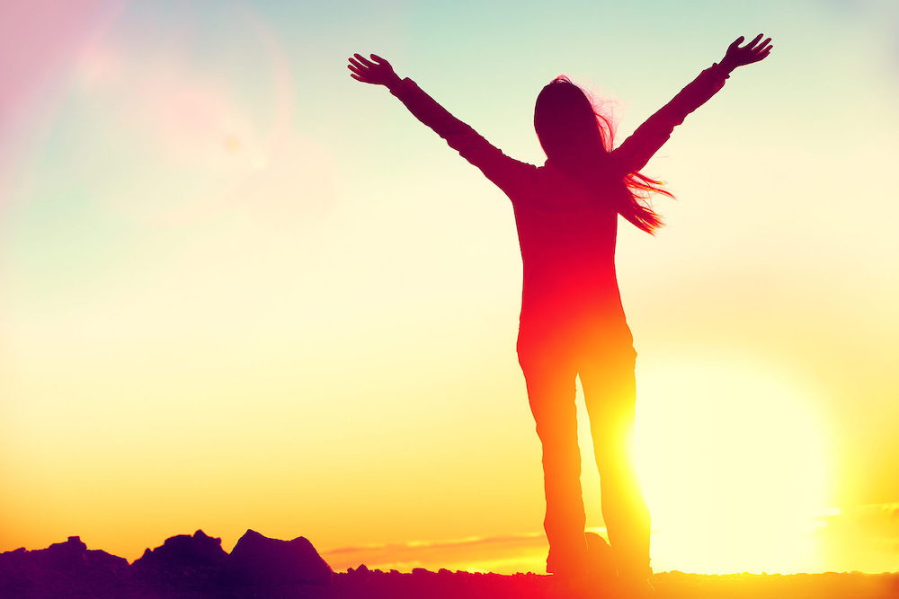 Image of a woman standing in the sunset with her arms up over her head. Discover the power of EMDR therapy in Las Vegas, NV and begin overcoming your anxiety symptoms.