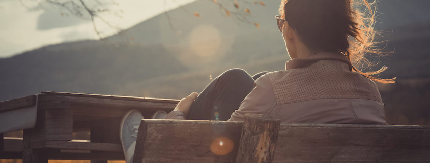 Image of a woman sitting on a bench while the sun sets. Do you struggle with anxiety? Learn how EMDR therapy in Las Vegas, NV can help you heal from your symptoms.