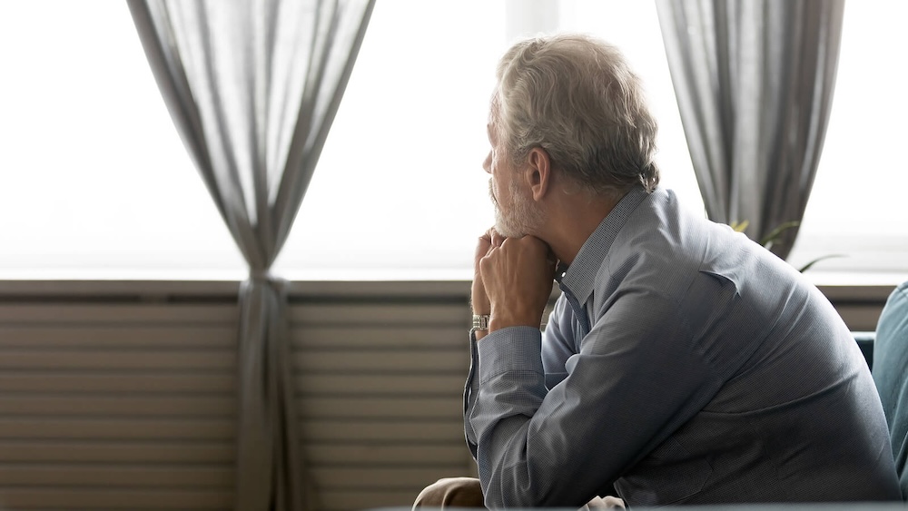 Image of an older man resting his head on his hands looking out a window. Do you struggle with BPD during the holidays? Learn how borderline personality disorder therapy in Las Vegas, NV can help you cope with holiday stress.