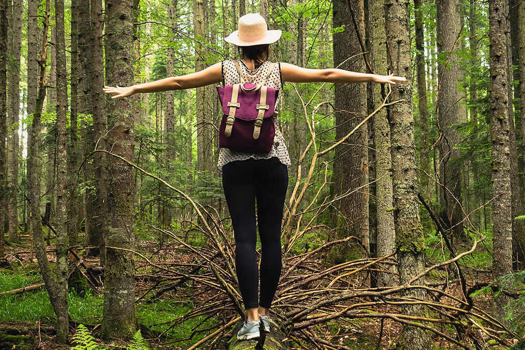 Image of a woman standing on a fallen tree trunk in the middle of a forest with her arms out for balance. Discover how effective borderline personality disorder therapy in Las Vegas, NV is to help you manage your BPD symptoms and live a more positive life.