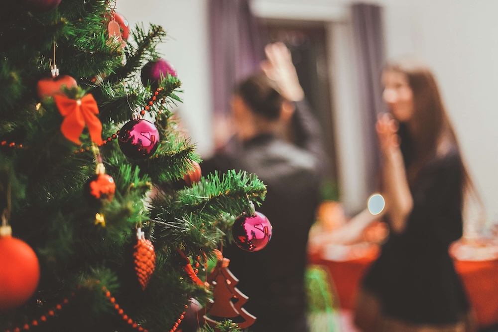 Image of multiple people at a holiday party with a Christmas tree. Struggling with BPD during the holidays? With the help of a borderline personality disorder therapist in Las Vegas, NV you can find support to manage your symptoms.