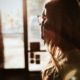 Image of a woman looking out a window with the sun shining on her face. Discover how EMDR therapy in Las Vegas, NV can help you cope with your depression symptoms.