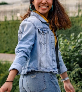 Image of a smiling Asian woman turning around wearing a jean jacket. If you struggle with managing your DID symptoms, learn how EMDR therapy in Las Vegas, NV can help.
