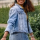 Image of a smiling Asian woman turning around wearing a jean jacket. If you struggle with managing your DID symptoms, learn how EMDR therapy in Las Vegas, NV can help.