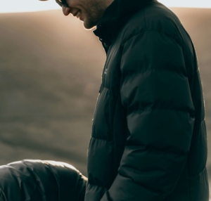 Image of a man standing outside wearing a puffy coat and smiling. Learn to find your resilience and happiness with the help of DBT therapy and EMDR therapy in Las Vegas, NV.