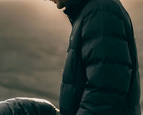 Image of a man standing outside wearing a puffy coat and smiling. Learn to find your resilience and happiness with the help of DBT therapy and EMDR therapy in Las Vegas, NV.
