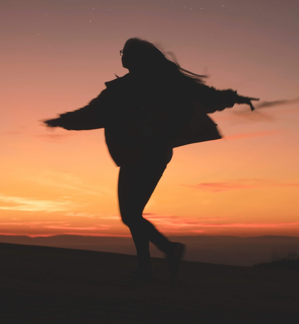 Image of a woman twirling around during sunset. Work towards overcoming your phobias with the help of EMDR therapy in Las Vegas, NV.