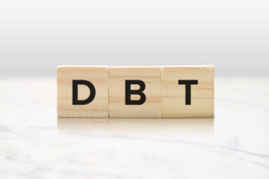 A close up of wooden blocks that spell DBT. Learn how a DBT therapist in Torrance, CA can offer support via online DBT therapy and more. Search for EMDR therapy for depression in Las Vegas, NV, and more.
