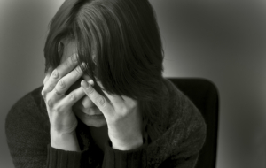 A close up of a woman covering her face while hiding a stressed expression. Learn more about how DBT therapy in Las Vegas, NV can offer support with addressing depression and mental health concerns. Search for online DBT therapy in Las Vegas by searching for online DBT therapy in Las Vegas today.