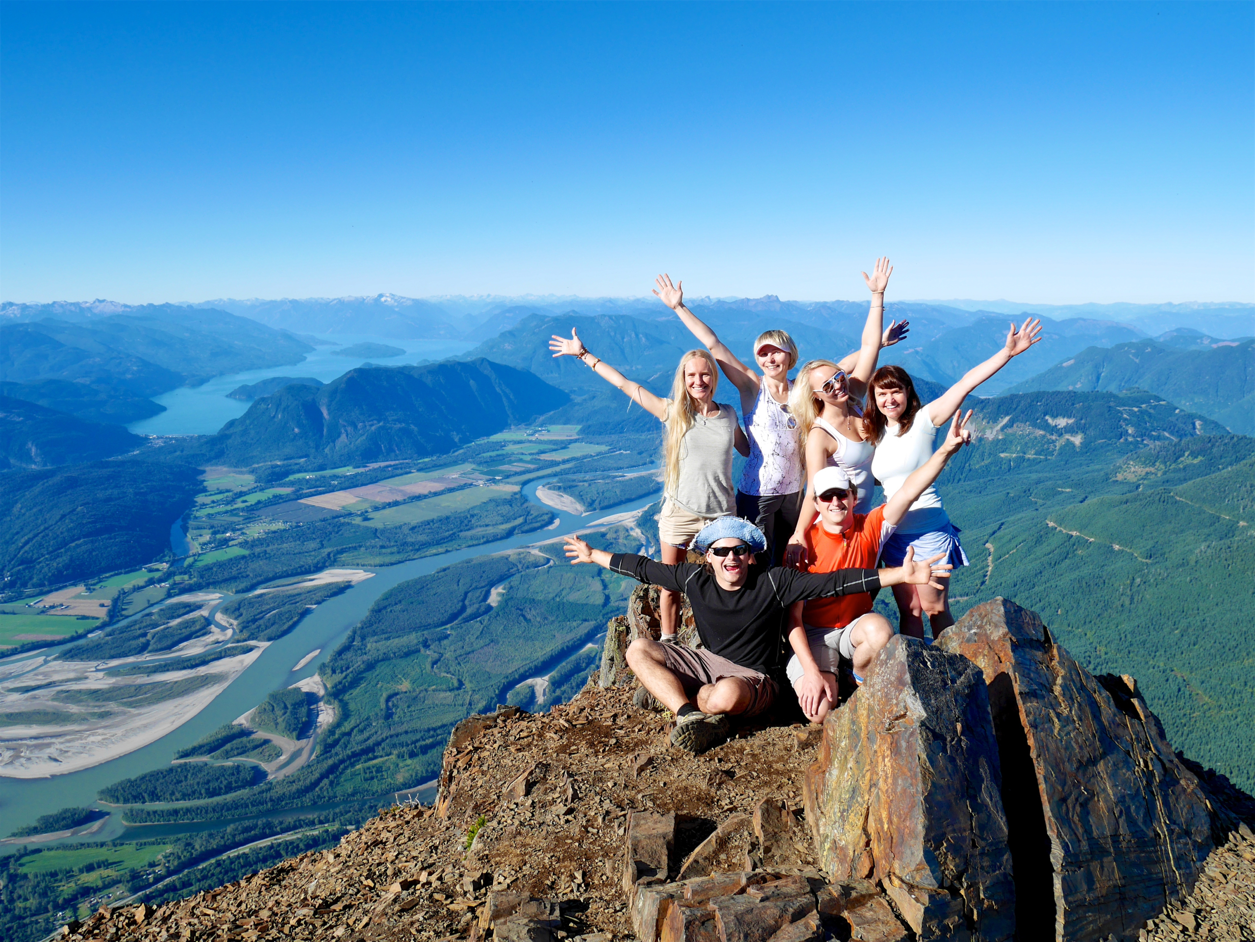 Group of friends celebrating at a mountain summit — symbolizing the long-term positives in DBT and how steady effort leads to meaningful rewards.
