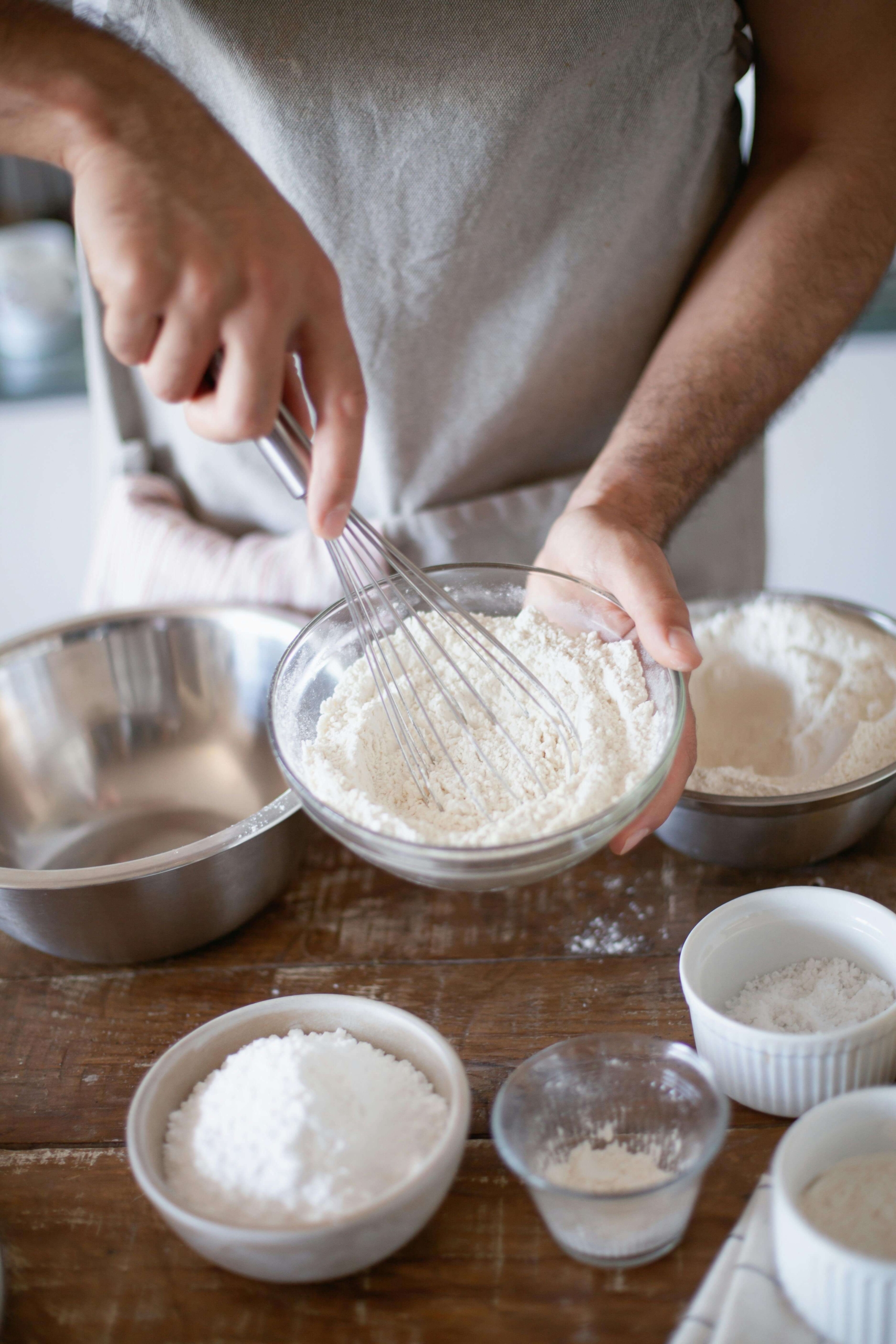 Picture of a man whisking flour in a glass bowl on a rustic kitchen table. Are you looking to practice DBT skills and find structure while managing your emotions? A DBT group led by a therapist in Las Vegas, NV, can help you feel more grounded and in control.