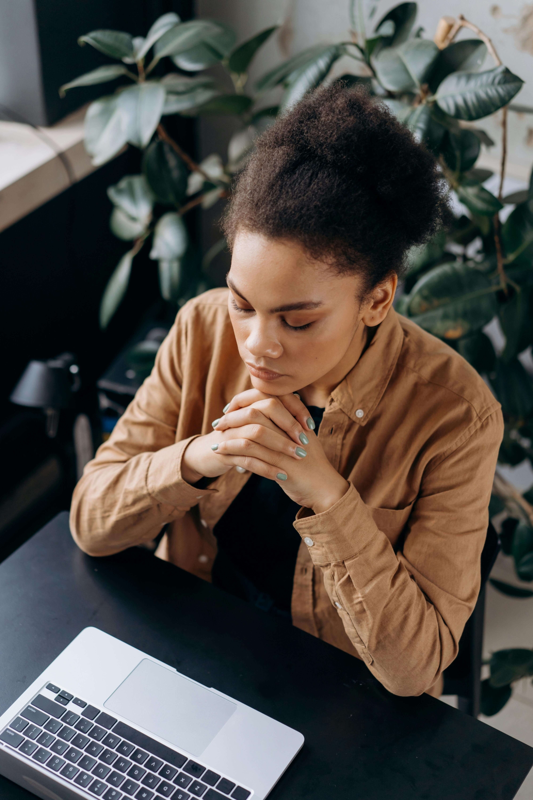 A woman sitting at a desk with her hands clasped in thought. Interested in learning DBT skills or preparing to cope with emotional challenges? A DBT therapist in Las Vegas, NV, can guide you through DBT group therapy to help you manage stress effectively.