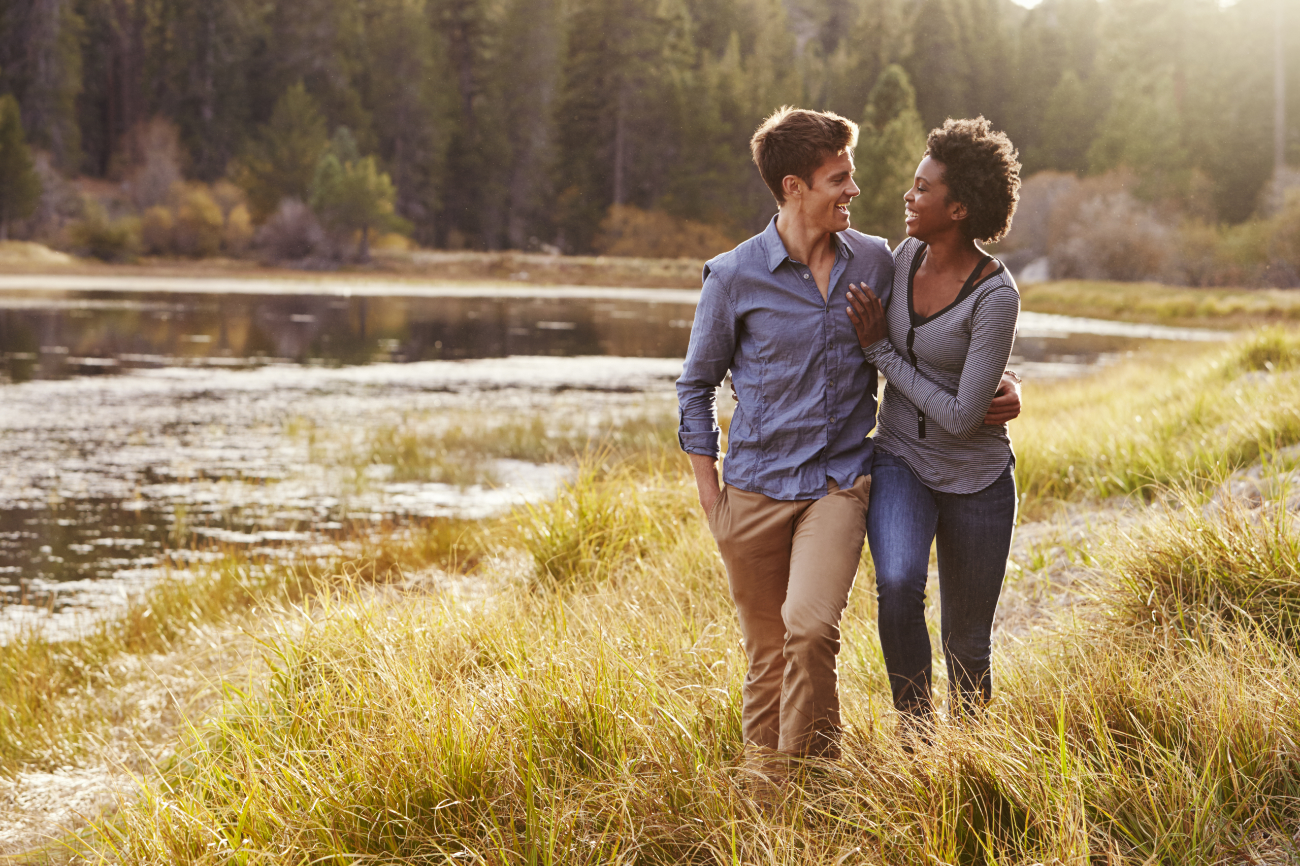 Couple smiling together, showing closeness and emotional security in their relationship.