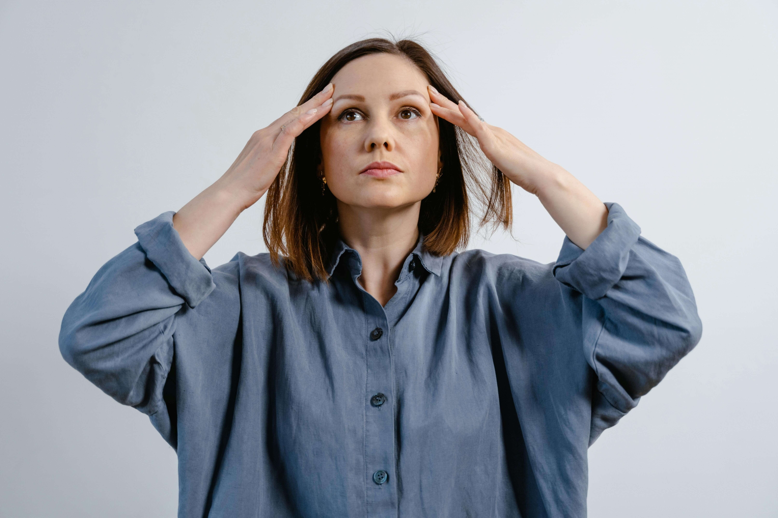 A stressed woman in a blue shirt holds her temples while looking upward. Does saying no feel impossible when you're overwhelmed by competing demands? A DBT skills group in Torrance, CA, teaches how to set boundaries while maintaining important relationships.